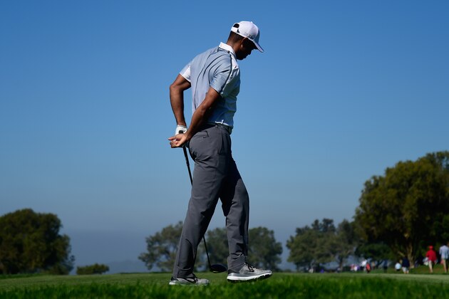 LA JOLLA, CA - FEBRUARY 05:  Tiger Woods  holds his back after playing his tee shot on the 15th hole of the north course during the first round of the Farmers Insurance Open at Torrey Pines Golf Course on February 5, 2015 in La Jolla, California.  (Photo by Donald Miralle/Getty Images)