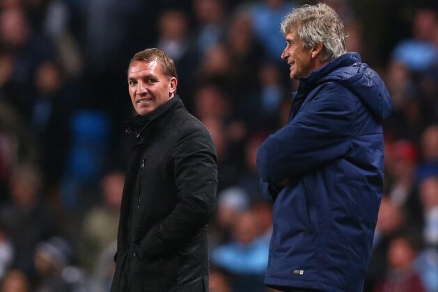 MANCHESTER, ENGLAND - AUGUST 25:  Manchester City Manager Manuel Pellegrini and Liverpool Manager Brendan Rodgers (L) smile during the Barclays Premier League match between Manchester City and Liverpool at the Etihad Stadium on August 25, 2014 in Manchester, England.  (Photo by Clive Brunskill/Getty Images)