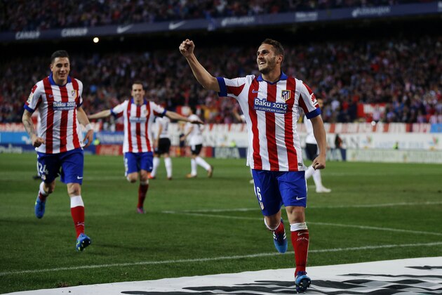 Atletico de Madrid’s Koke, right, celebrates after scoring a goal during a Spanish La Liga soccer match between Atletico de Madrid and Valencia at the Vicente Calderon stadium in Madrid, Spain, Sunday, March 8, 2015. (AP Photo/Daniel Ochoa de Olza)