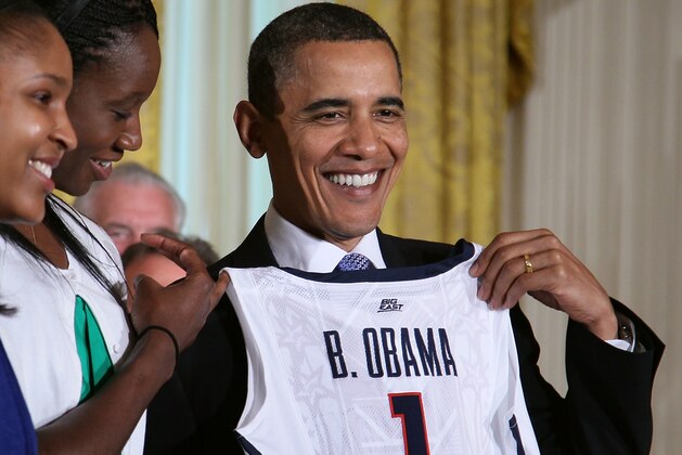 WASHINGTON - MAY 17:  U.S. President Barack Obama smiles while receiving a jersey from the NCAA champion, University of Connecticut women's basketball team in the East Room at the White House on May 17, 2010 in Washington, DC.  The Huskies were invited to the White House to recognize their seventh overall and second straight NCAA championship and back-to-back undefeated seasons.  (Photo by Mark Wilson/Getty Images)