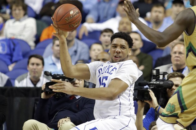 Duke's Jahlil Okafor (15) tries to pass the ball around Notre Dame's Jerian Grant (22) during the second half of an NCAA college basketball game in the semifinals of the Atlantic Coast Conference tournament in Greensboro, N.C., Friday, March 13, 2015. (AP Photo/Bob Leverone)