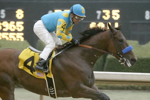 American Pharoah and jockey Victor Espinoza (4) win the $750,000 Rebel Stakes horse race at Oaklawn Park in Hot Springs, Ark., Saturday, March 14, 2015. (AP Photo/Danny Johnston)