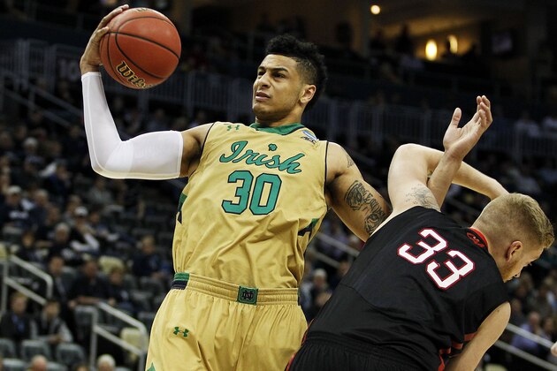 PITTSBURGH, PA - MARCH 19:  Zach Auguste #30 of the Notre Dame Fighting Irish rebounds against Zach Stahl #33 of the Northeastern Huskies in the first half during the second round of the 2015 NCAA Men's Basketball Tournament at Consol Energy Center on March 19, 2015 in Pittsburgh, Pennsylvania.  (Photo by Justin K. Aller/Getty Images)