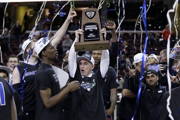 Buffalo head coach Bobby Hurley, center,  and teammates celebrate after Buffalo defeated Central Michigan 89-84 in an NCAA college basketball game in the championship of the Mid-American Conference tournament Saturday, March 14, 2015, in Cleveland.  (AP Photo/Tony Dejak)