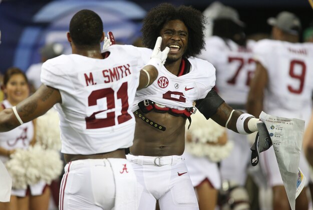 Dec 6, 2014; Atlanta, GA, USA;  Alabama Crimson Tide defensive back Maurice Smith (21) and defensive back Tony Brown (2) celebrate after defeating Missouri in the 2014 SEC Championship at the Georgia Dome. Alabama beat Missouri 42-13. Mandatory Credit: Jason Getz-USA TODAY Sports