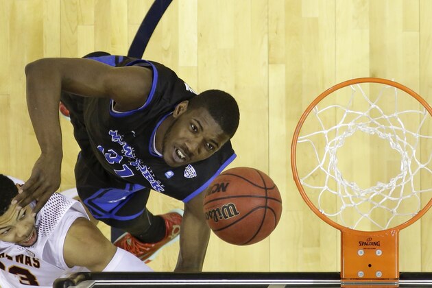 Central Michigan's DaRohn Scott drives to the basket against Buffalo's Raheem Johnson during the second half of an NCAA college basketball game in the championship of the Mid-American Conference tournament Saturday, March 14, 2015, in Cleveland. Buffalo defeated Central Michigan 89-84.(AP Photo/Tony Dejak)
