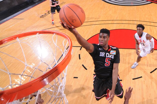 PORTLAND, OR - APRIL 12:  Emmanuel Mudiay #5 of the World Team drives to the basket against the USA Team on April 12, 2014 at the Moda Center Arena in Portland, Oregon. NOTE TO USER: User expressly acknowledges and agrees that, by downloading and or using this photograph, user is consenting to the terms and conditions of the Getty Images License Agreement. Mandatory Copyright Notice: Copyright 2014 NBAE (Photo by Sam Forencich/NBAE via Getty Images)