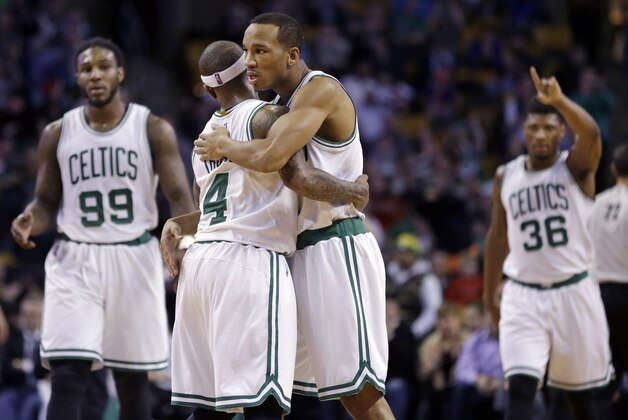Boston Celtics guard Avery Bradley, right, hugs teammate Isaiah Thomas (4) as forward Jae Crowder (99) and guard Marcus Smart (36) gesture during the last minutes of the fourth quarter against the New York Knicks in an NBA basketball game in Boston, Wednesday, Feb. 25, 2015. The Celtics won 115-94. (AP Photo/Elise Amendola)