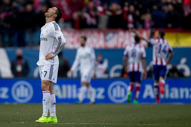 MADRID, SPAIN - FEBRUARY 07:  Cristiano Ronaldo of Real Madrid CF reacts defeated as behind Mario Mandzukic of Atletico de Madrid celebrates scoring their fourth goal with teammates during the La Liga match between Club Atletico de Madrid and Real Madrid CF at Vicente Calderon Stadium on February 7, 2015 in Madrid, Spain.  (Photo by Gonzalo Arroyo Moreno/Getty Images)