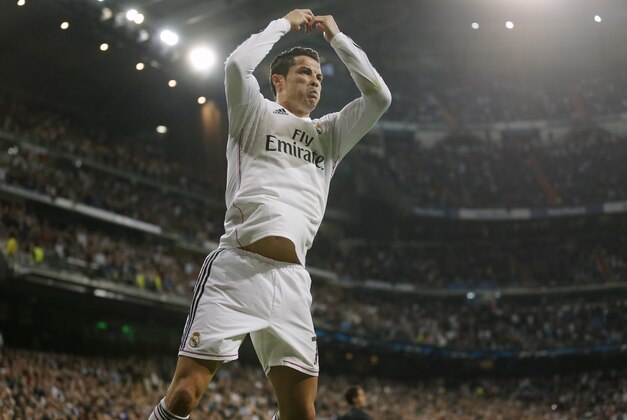 Real Madrid's Cristiano Ronaldo celebrates scoring 2-2 during a Champions League soccer match round of 16 second leg, between Real Madrid and Schalke 04 at Santiago Bernabeu stadium, in Madrid, Spain, Tuesday, March 10, 2015. (AP Photo/Daniel Ochoa de Olza)