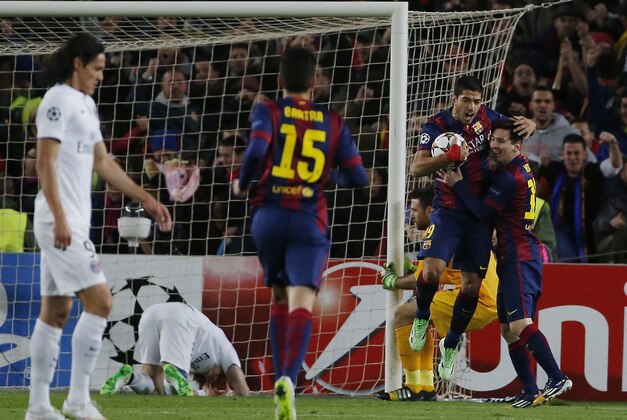 Barcelona's Lionel Messi, right, and his teammate Luis Suarez celebrate the first goal of their team during a Group F Champions League soccer match between FC Barcelona and PSG at the Camp Nou stadium in Barcelona, Spain, Wednesday Dec. 10, 2014. (AP Photo/Emilio Morenatti)