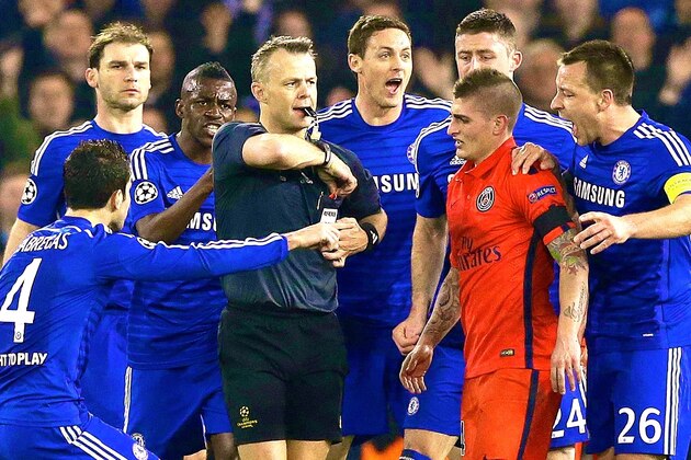 FILE - In this Wednesday, March 11, 2015 file photo Chelsea players remonstrate with referee Bjorn Kuipers just before he showed a red card to PSG's Zlatan Ibrahimovic during the Champions League round of 16 second leg soccer match between Chelsea and Paris Saint Germain at Stamford Bridge stadium in London. (AP Photo/Matt Dunham, File)