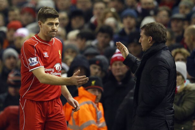 Liverpool's Steven Gerrard shakes hands with manager Brendan Rodgers as he is substituted during the English Premier League soccer match between Liverpool and Tottenham Hotspur at Anfield Stadium, Liverpool, England, Tuesday Feb. 10, 2015. (AP Photo/Jon Super)