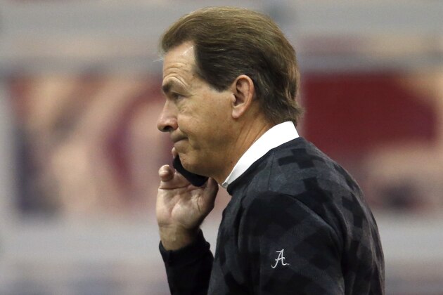 Alabama head coach Nick Saban talks on his cell phone at Alabama's Pro Day, Wednesday, March 11, 2015, in Tuscaloosa, Ala. The event is to showcase players for the upcoming NFL football draft. (AP Photo/Butch Dill)