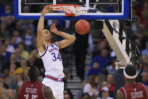 Kansas' Perry Ellis dunks as New Mexico State's DK Eldridge, right, and Tshilidzi Nephawe (15) watch during the first half of an NCAA tournament college basketball game in the Round of 64 in Omaha, Neb., Friday, March 20, 2015. (AP Photo/Nati Harnik)