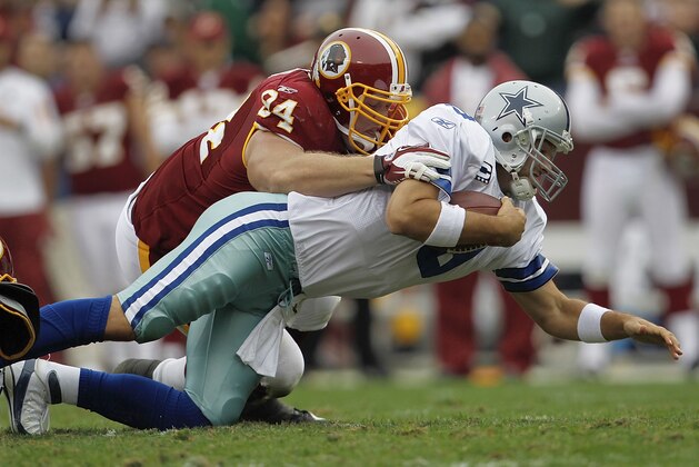 Dallas Cowboys quarterback Tony Romo is sacked by Washington Redskins defensive end Adam Carriker during the first half of an NFL football game in Landover, Md., on Sunday, Nov. 20, 2011.  (AP Photo/Pablo Martinez Monsivais)