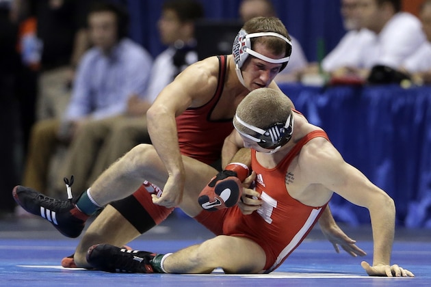 Nebraska’s Anthony Abidin, bottom, wrestles with Ohio State’s Logan Stieber during their 141-pound quarterfinal match, Friday, March 20, 2015, at the NCAA Division I Wrestling Championships in St. Louis. (AP Photo/Jeff Roberson)