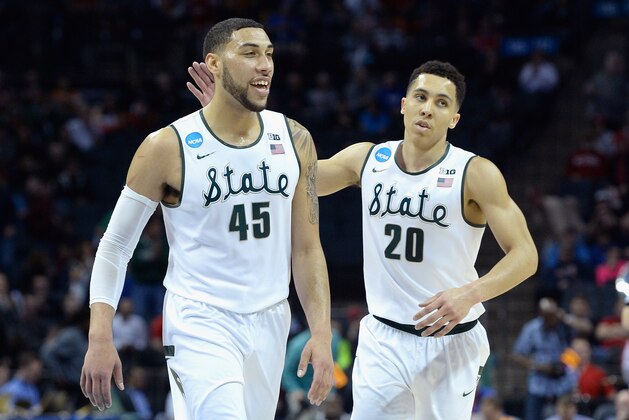 CHARLOTTE, NC - MARCH 20:  Teammates Denzel Valentine #45 and Travis Trice #20 of the Michigan State Spartans react against the Georgia Bulldogs during the second round of the 2015 NCAA Men's Basketball Tournament at Time Warner Cable Arena on March 20, 2015 in Charlotte, North Carolina.  (Photo by Grant Halverson/Getty Images)