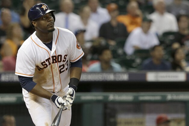 Houston Astros' Chris Carter watches his two-run home run against the Los Angeles Angels in the eighth inning of a baseball game Wednesday, Sept. 3, 2014, in Houston. The Astros won 4-1. (AP Photo/Pat Sullivan)