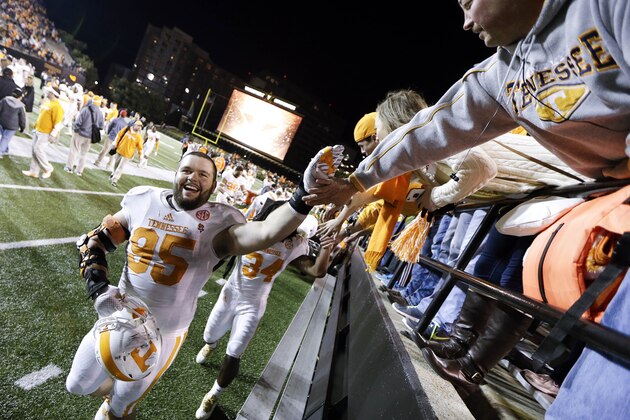 Tennessee defensive lineman Danny O'Brien (95) celebrates with fans as he leaves the field following a 24-17 win over Vanderbilt in an NCAA college football game Saturday, Nov. 29, 2014, in Nashville, Tenn. (AP Photo/Mark Humphrey)