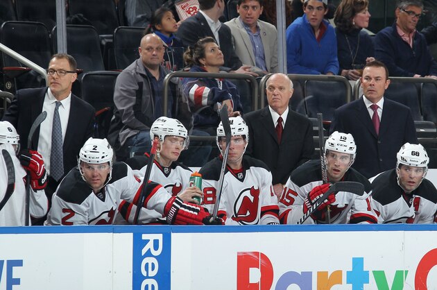 NEW YORK, NY - DECEMBER 27:  Interim coach Lou Lamoriello and Co-coaches Adam Oates and Scott Stevens of the New Jersey Devils follow the action from the bench during the game against the New York Rangers at Madison Square Garden on December 27, 2014 in New York City. (Photo by Jared Silber/NHLI via Getty Images)