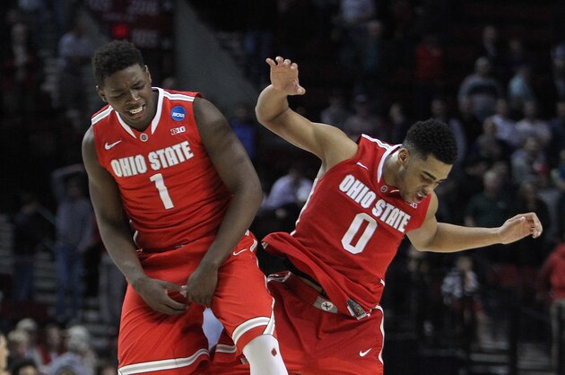 Ohio State guard D'Angelo Russell, right, celebrates with teammate Jae'Sean Tate after winning an NCAA tournament college basketball second round game against Virginia Commonwealth, Thursday, March 19, 2015, in Portland, Ore. Russell led Ohio State in scoring with 28 points as they won 75-72 in overtime. (AP Photo/Craig Mitchelldyer)