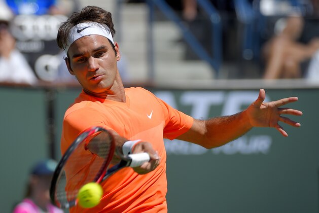 Roger Federer, of Switzerland, returns a volley from to Tomas Berdych, of the Czech Republic, during their match at the BNP Paribas Open tennis tournament, Friday, March 20, 2015 in Indian Wells, Calif. Federer won 6-4, 6-0. (AP Photo/Mark J. Terrill)
