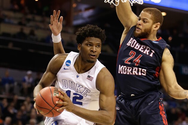 CHARLOTTE, NC - MARCH 20:  Justise Winslow #12 of the Duke Blue Devils drives past Aaron Tate #24 of the Robert Morris Colonials during the second round of the 2015 NCAA Men's Basketball Tournament at Time Warner Cable Arena on March 20, 2015 in Charlotte, North Carolina.  (Photo by Bob Leverone/Getty Images)