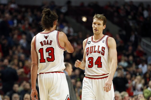 Chicago Bulls center Joakim Noah and forward Mike Dunleavy against the Boston Celtics during an NBA basketball game in Chicago, Monday, March 31, 2014. The Bulls won 94-80. (AP Photo/Kamil Krzaczynski)