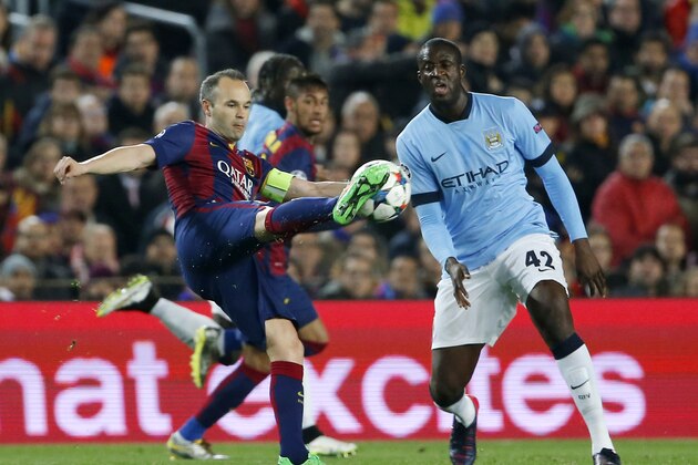 Barcelona's Andres Iniesta, left, controls the ball past Manchester City's Yaya Toure during a Champions League round of 16 second leg, soccer match between FC Barcelona and Manchester City at Camp Nou stadium, in Barcelona, Spain, Wednesday, March 18, 2015. (AP Photo/Emilio Morenatti)