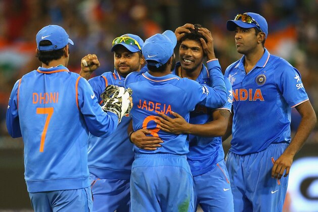 MELBOURNE, AUSTRALIA - MARCH 19:  Umesh Yadav of India is congratulated by team mates after getting the wicket of Mushfiqur Rahim of Bangladesh during the 2015 ICC Cricket World Cup Quater Final match between India and Bangldesh at Melbourne Cricket Ground on March 19, 2015 in Melbourne, Australia.  (Photo by Quinn Rooney/Getty Images)
