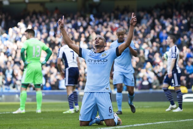 Manchester City's Fernando, centre, celebrates after scoring against West Bromwich Albion during the English Premier League soccer match between Manchester City and West Bromwich Albion at the Etihad Stadium, Manchester, England, Saturday March 21, 2015. (AP Photo/Jon Super)