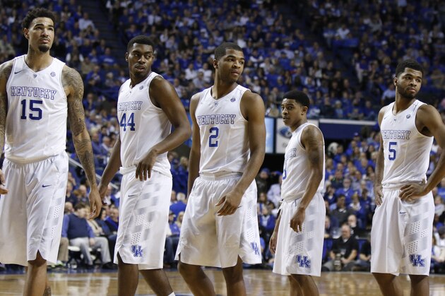 Kentucky players, from left, Willie Cauley-Stein, Dakari Johnson, Aaron Harrison, Tyler Ulis and Andrew Harrison re-enter the game during the second half of an NCAA college basketball game against Florida, Saturday, March 7, 2015, in Lexington, Ky. Kentucky won 67-50. (AP Photo/James Crisp)
