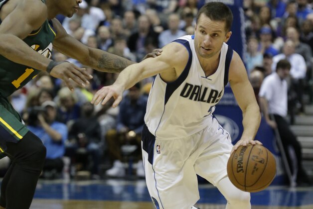 Dallas Mavericks guard J.J. Barea (5) drives against Utah Jazz guard Dante Exum (11) during the second half of an NBA basketball game Wednesday, Feb. 11, 2015, in Dallas. (AP Photo/LM Otero)