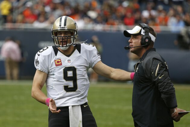 New Orleans Saints quarterback Drew Brees (9) talks to head coach Sean Payton during the second half of an NFL football game against the Chicago Bears, Sunday, Oct. 6, 2013, in Chicago.(AP Photo/Charles Rex Arbogast)