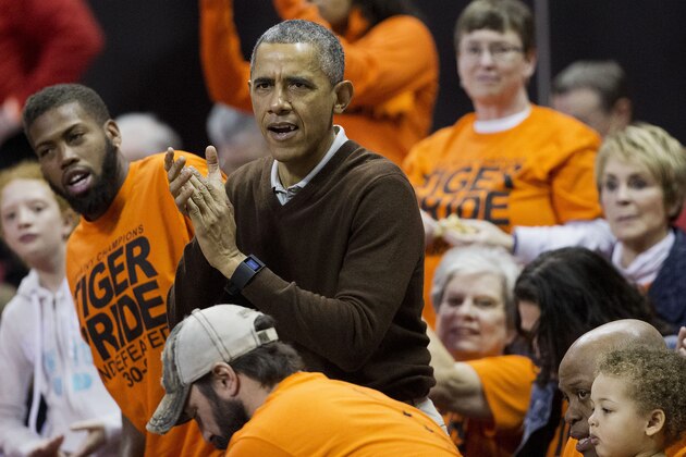 President Barack Obama cheers at the Princeton game against Wisconsin-Green Bay women's college basketball game in the first round of the NCAA tournament in College Park, Md., Saturday, March 21, 2015. Obama's niece Leslie Robinson, plays for Princeton.(AP Photo/Pablo Martinez Monsivais)