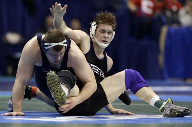 Northwestern's Michael McMullan, right, wrestles with Michigan's Adam Coon during their 285-pound semifinal match Friday, March 20, 2015, at the NCAA Division I Wrestling Championships in St. Louis. (AP Photo/Jeff Roberson)
