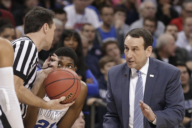Duke head coach Mike Krzyzewski, right, talks to a referee during the first half of an NCAA tournament college basketball game against Robert Morris in the Round of 64 in Charlotte, N.C., Friday, March 20, 2015. (AP Photo/Nell Redmond)