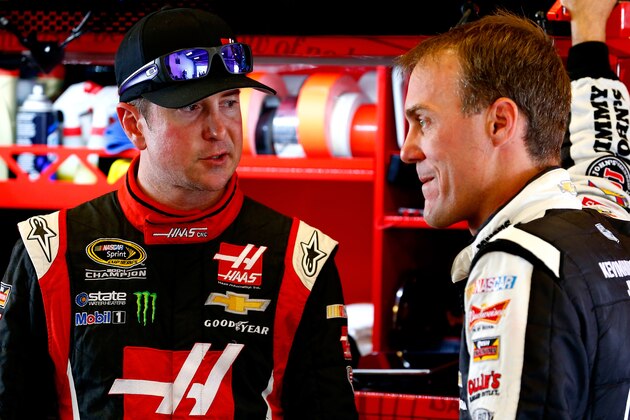INDIANAPOLIS, IN - JULY 26:  Kurt Busch, driver of the #41 Haas Automation Chevrolet, left, talks with Kevin Harvick, driver of the #4 Jimmy John's Chevrolet, in the garage area during practice for the NASCAR Sprint Cup Series Crown Royal Presents The John Wayne Walding 400 at the Brickyard Indianapolis Motor Speedway on July 26, 2014 in Indianapolis, Indiana.  (Photo by Sean Gardner/Getty Images)