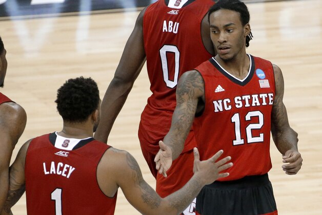 North Carolina State's Anthony Barber (12) greets Trevor Lacey (1) after scoring against Villanova during the second half of an NCAA college basketball tournament Round of 32 game Saturday, March 21, 2015, in Pittsburgh. (AP Photo/Gene J. Puskar)