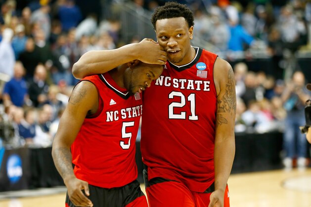 PITTSBURGH, PA - MARCH 21: Desmond Lee #5 and Beejay Anya #21 of the North Carolina State Wolfpack celebrate as they walk off the floor following their 71-68 win over the Villanova Wildcats  during the third round of the 2015 NCAA Men's Basketball Tournament at Consol Energy Center on March 21, 2015 in Pittsburgh, Pennsylvania.  (Photo by Jared Wickerham/Getty Images)