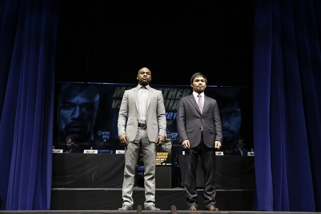 Boxers Floyd Mayweather Jr., left, and Manny Pacquiao, of the Philippines, pose for photos during a news conference, Wednesday, March 11, 2015, in Los Angeles. The two are scheduled to fight in Las Vegas on May 2. (AP Photo/Jae C. Hong)