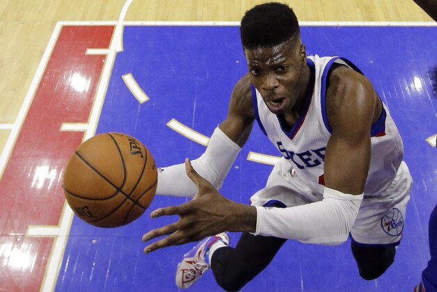 Philadelphia 76ers' Nerlens Noel, left, goes up to shoot against New York Knicks' Quincy Acy during the second half of an NBA basketball game, Friday, March 20, 2015, in Philadelphia. Philadelphia won 97-81. (AP Photo/Matt Slocum)