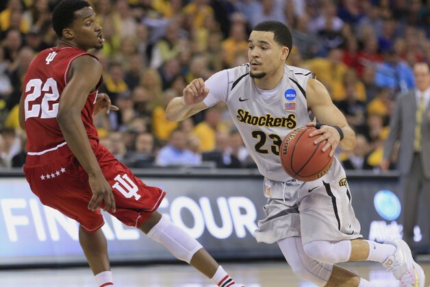 Wichita State's Fred VanVleet (23) drives to the basket against Indiana's Stanford Robinson (22) during the first half of an NCAA tournament college basketball game in the Round of 64 in Omaha, Neb., Friday, March 20, 2015. (AP Photo/Nati Harnik)