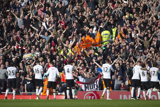 Manchester United players celebrate in front of their supporters after the team's 2-1 win during the English Premier League soccer match between Liverpool and Manchester United at Anfield Stadium, Liverpool, England, Sunday, March 22, 2015. (AP Photo/Jon Super)
