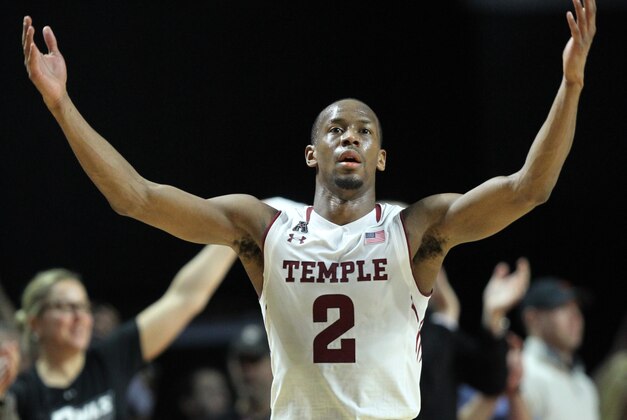 Temple guard Will Cummings (2) raises his hands to celebrate after defeating Connecticut 75-63 in an NCAA college basketball game, Saturday, March 7, 2015, in Philadelphia. (AP Photo/Laurence Kesterson)