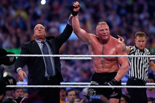 Paul Heyman, left, celebrates with Brock Lesnar after his win over the Undertaker  during Wrestlemania XXX at the Mercedes-Benz Super Dome in New Orleans on Sunday, April 6, 2014. (Jonathan Bachman/AP Images for WWE)