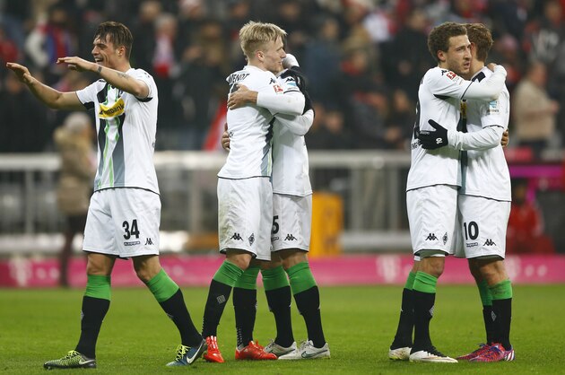 Moenchengladbach's players celebrate after winning the German first division Bundesliga soccer match between FC Bayern Munich and Borussia Moenchengladbach in the Allianz Arena in Munich, Germany, on Sunday, March 22, 2015. Moenchengladbach won 0-2. (AP Photo/Matthias Schrader)