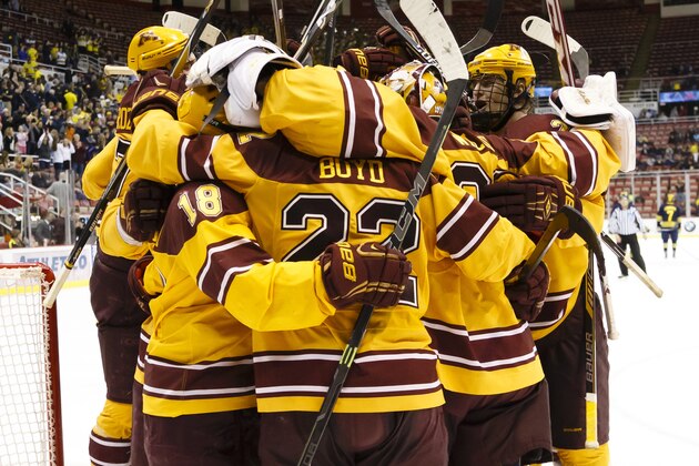 Minnesota players celebrate after an NCAA college hockey game against Michigan in the Big Ten Conference tournament Saturday, March 21, 2015, in Detroit. Minnesota defeated Michigan 4-2 to win the Big Ten Championship tournament. (AP Photo/Rick Osentoski)