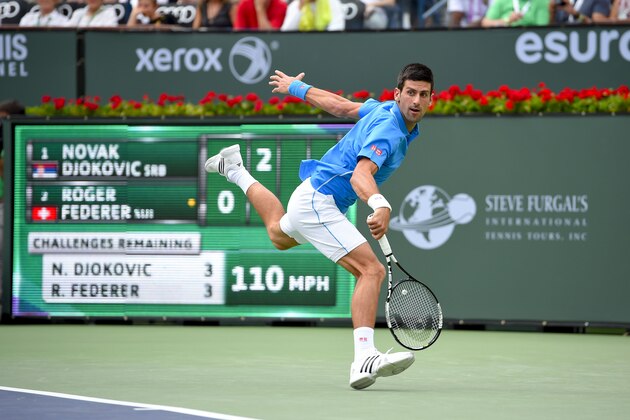 Novak Djokovic, of Serbia, returns to Roger Federer, of Switzerland, during their final match at the BNP Paribas Open tennis tournament, Sunday, March 22, 2015, in Indian Wells, Calif. (AP Photo/Mark J. Terrill)